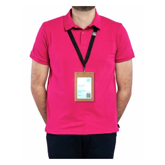 A person wearing a pink polo shirt with a lanyard displaying a badge. The badge has details including a name, event type, and QR code.