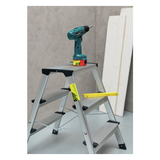 Ladder with a cordless drill and measuring tape on it, against a neutral background.