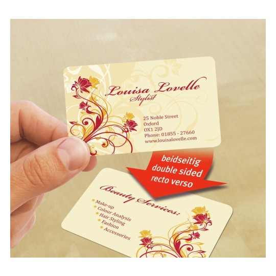 La imagen muestra una tarjeta de presentación de una estilista llamada Louisa Lovelle. La tarjeta tiene un diseño floral en colores cálidos y contiene información de contacto, así como una lista de servicios de belleza.