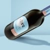 bottiglia di vino con una etichetta a forma di arco stampata con l'informazioni sul vino