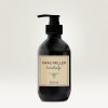 Un flacone di sapone liquido per le mani di colore nero con un'etichetta che mostra 'FRAU MILLER handseife' e un volume di 200 ml.