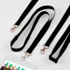 Lanyards in black with gold clips, laid out on a light surface. Includes one with a badge holder.
