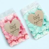 due confezioni di caramelle con applicate delle etichette a forma di cuore stampate